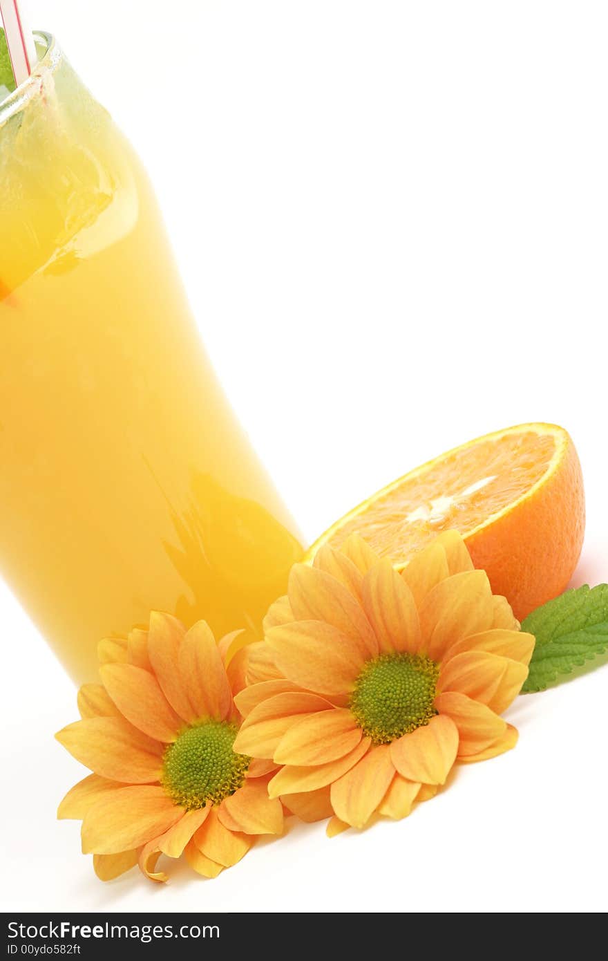 Glass of orange juice and flowers against white background. Glass of orange juice and flowers against white background