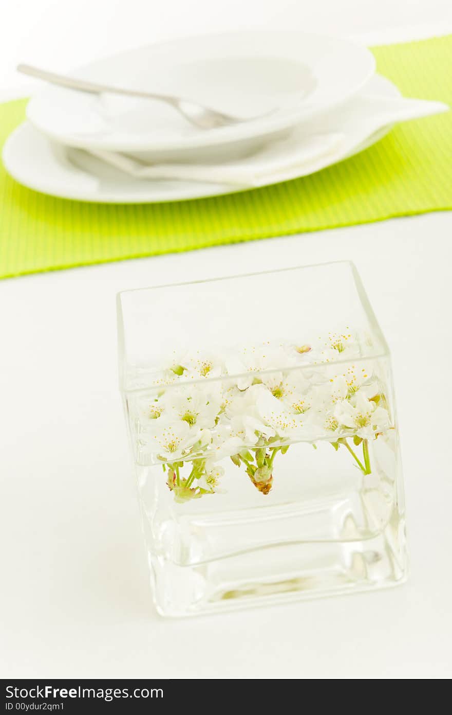 Kitchen table setup with cherry flowers and plates