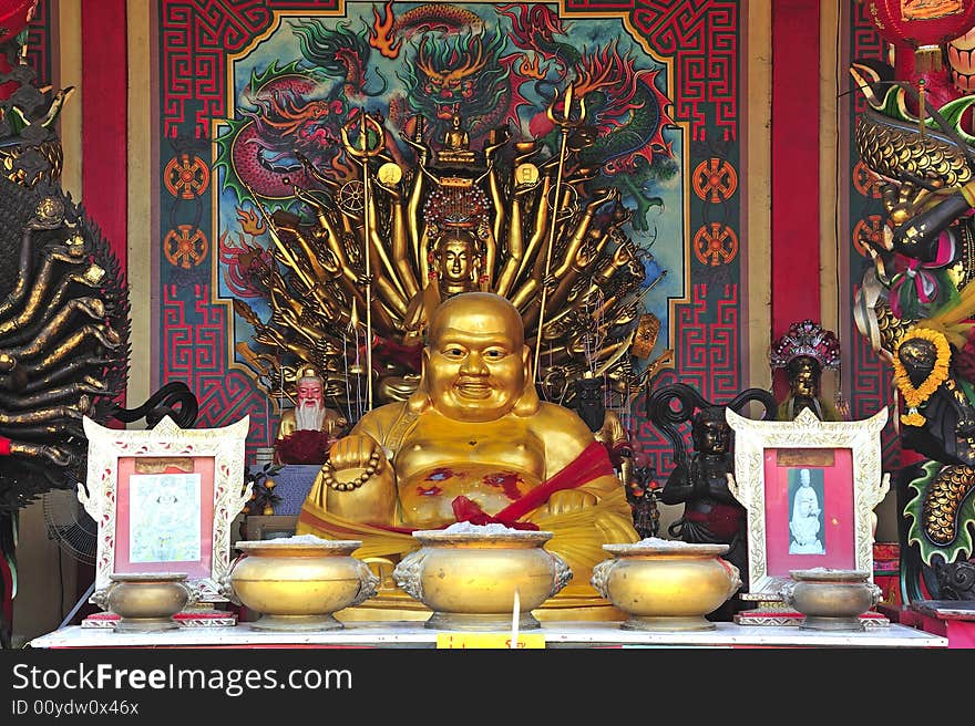 In Thailand the city of Ayutthaya was founded in 1350 today is an impressive archaeological park; here a view of seated Buddha on a Chinese temple on the back of Wat Phanan-Choeng. In Thailand the city of Ayutthaya was founded in 1350 today is an impressive archaeological park; here a view of seated Buddha on a Chinese temple on the back of Wat Phanan-Choeng