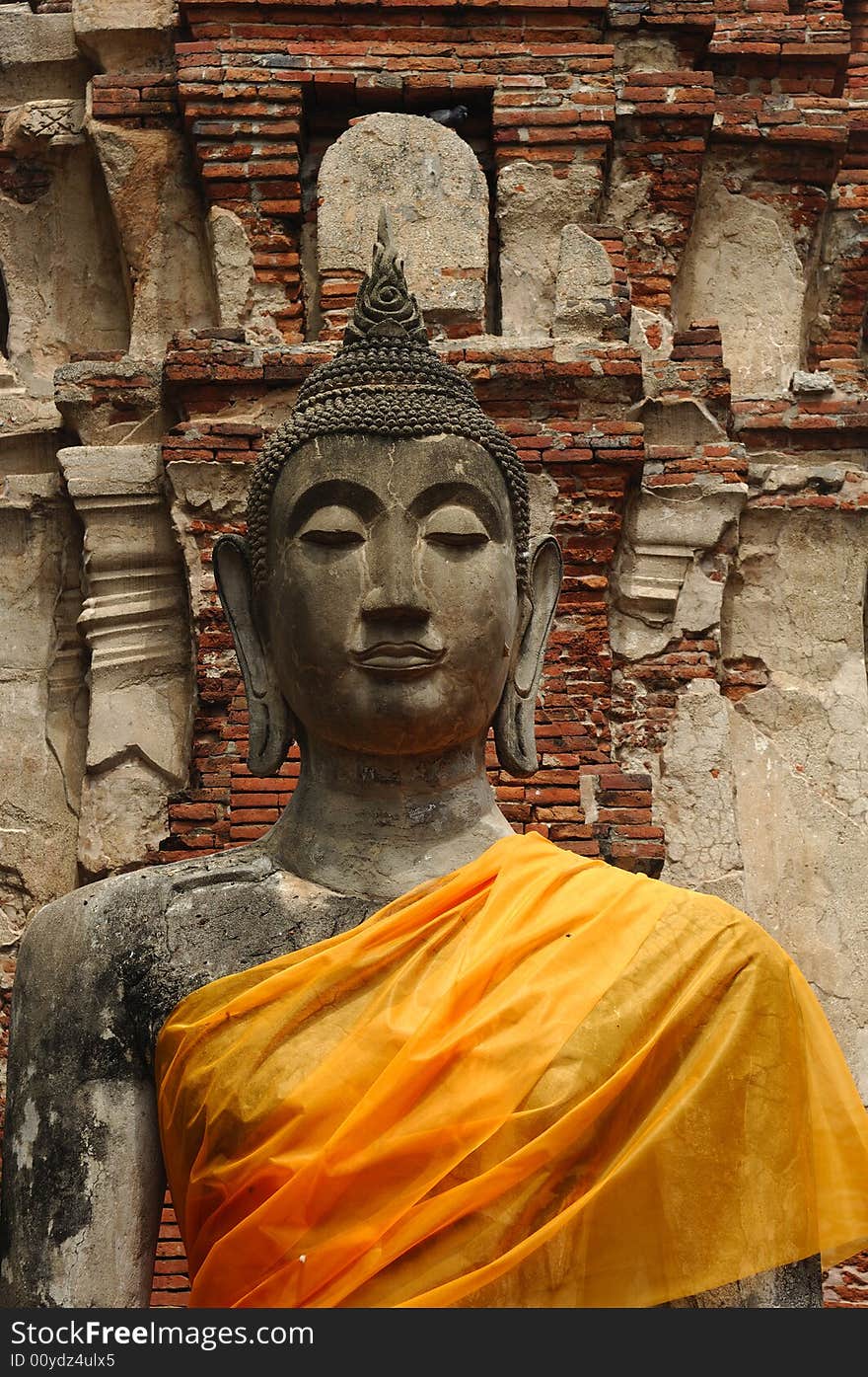 In Thailand the city of Ayutthaya was founded in 1350 today is an impressive archaeological park; here an ancient seated  buddha at the Wat Phra Mahathat. In Thailand the city of Ayutthaya was founded in 1350 today is an impressive archaeological park; here an ancient seated  buddha at the Wat Phra Mahathat