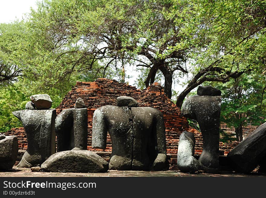 In Thailand the city of Ayutthaya was founded in 1350 today is an impressive archaeological park; here a view of the Wat Ratburana or Ratchaburana ruins built in 1424 with an ancient statue of Buddha. In Thailand the city of Ayutthaya was founded in 1350 today is an impressive archaeological park; here a view of the Wat Ratburana or Ratchaburana ruins built in 1424 with an ancient statue of Buddha