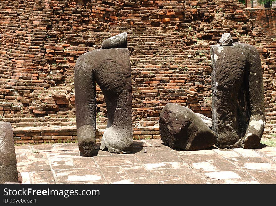 In Thailand the city of Ayutthaya was founded in 1350 today is an impressive archaeological park; here a view of the Wat Ratburana or Ratchaburana ruins built in 1424 with an ancient statue of Buddha. In Thailand the city of Ayutthaya was founded in 1350 today is an impressive archaeological park; here a view of the Wat Ratburana or Ratchaburana ruins built in 1424 with an ancient statue of Buddha