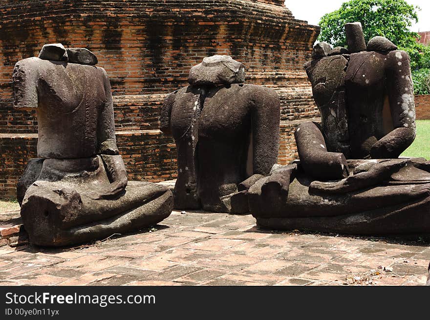 In Thailand the city of Ayutthaya was founded in 1350 today is an impressive archaeological park; here a view of the Wat Ratburana or Ratchaburana ruins built in 1424 with ancient statue of Buddha. In Thailand the city of Ayutthaya was founded in 1350 today is an impressive archaeological park; here a view of the Wat Ratburana or Ratchaburana ruins built in 1424 with ancient statue of Buddha