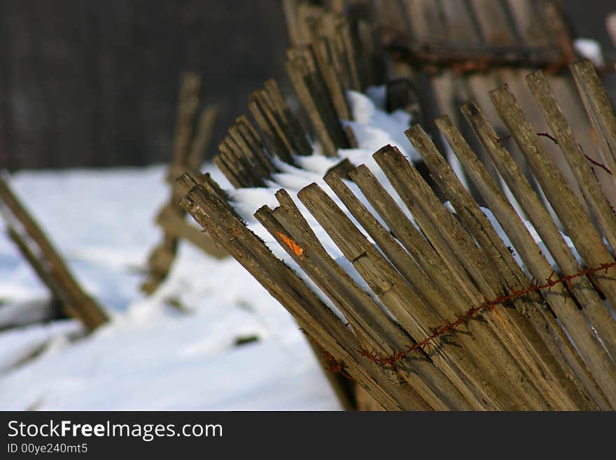 A bent fence in the winter. A bent fence in the winter