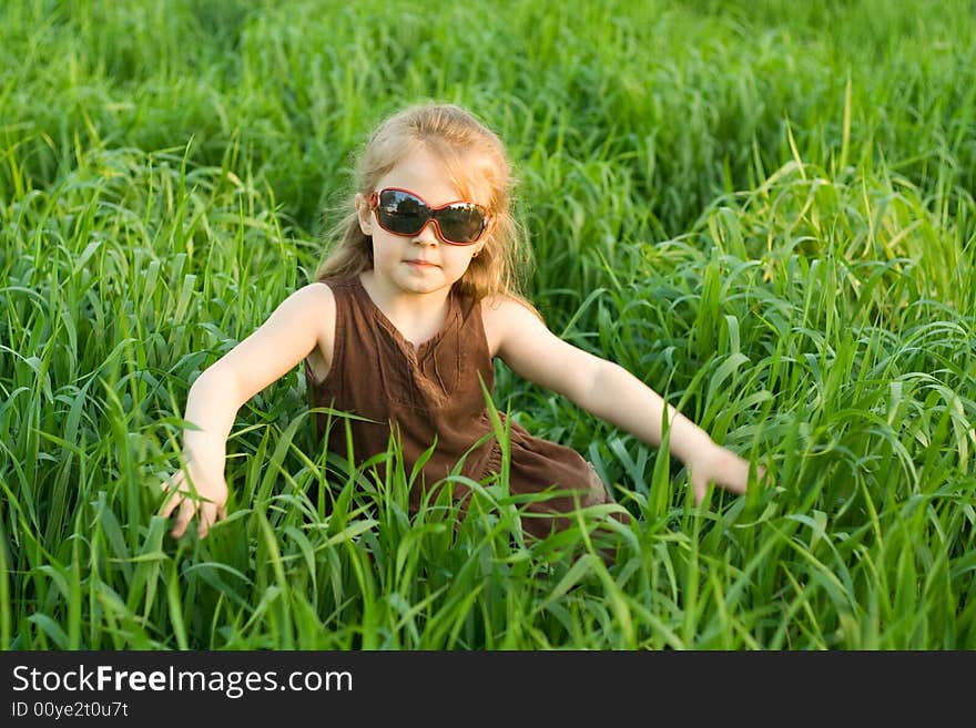 The child in a high marsh grass. The child in a high marsh grass