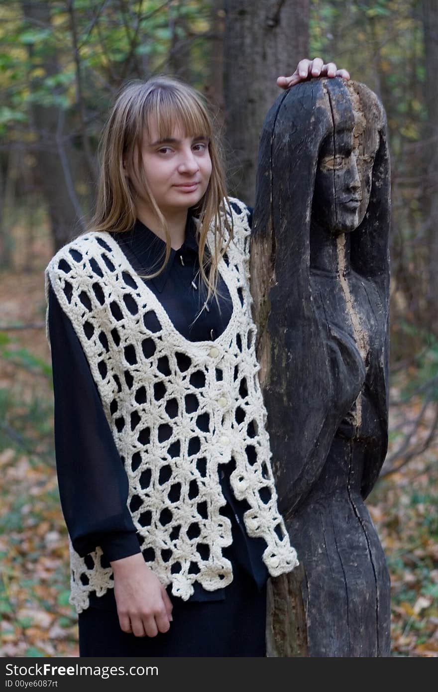 Girl and wooden statue