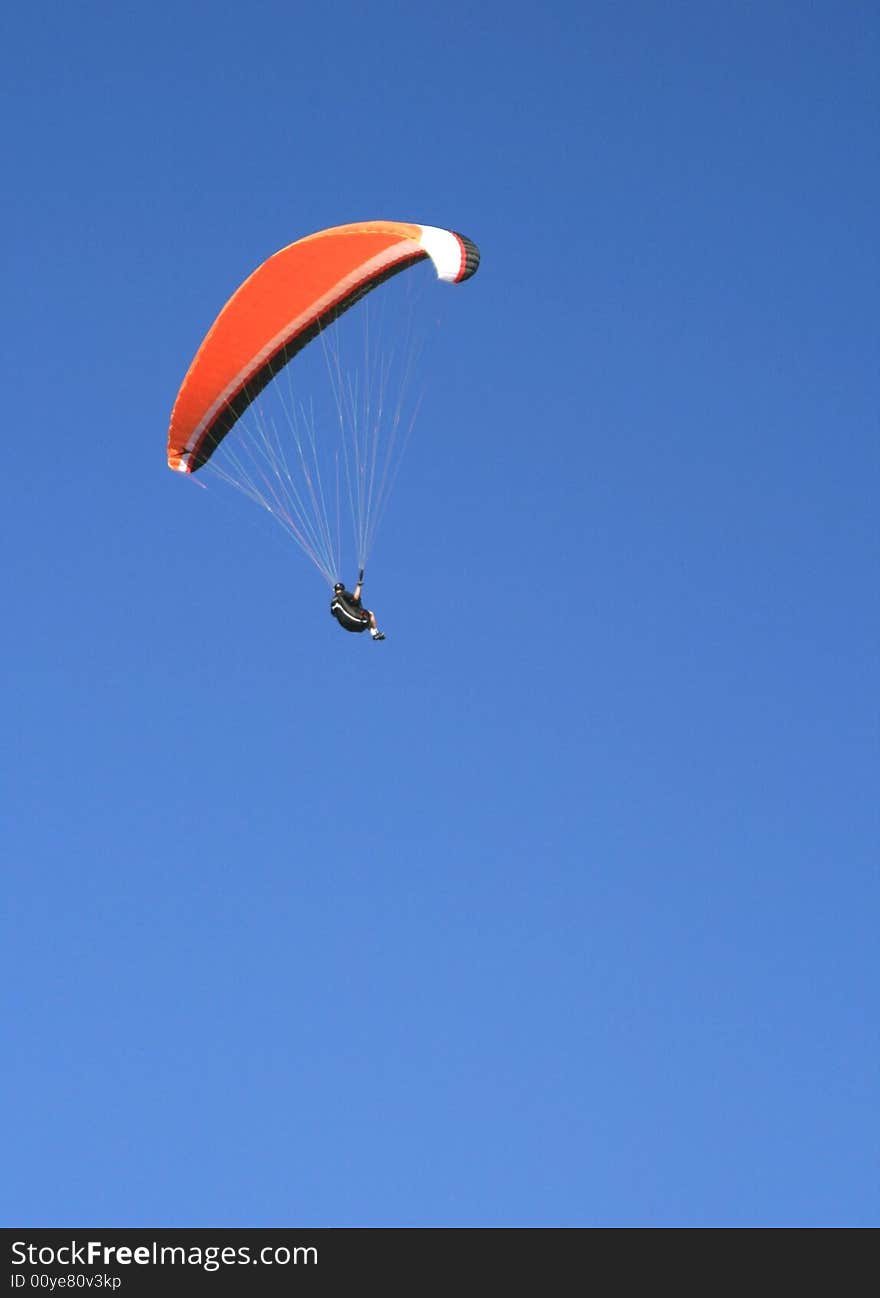 Paraglider flying against the blue sky. Paraglider flying against the blue sky