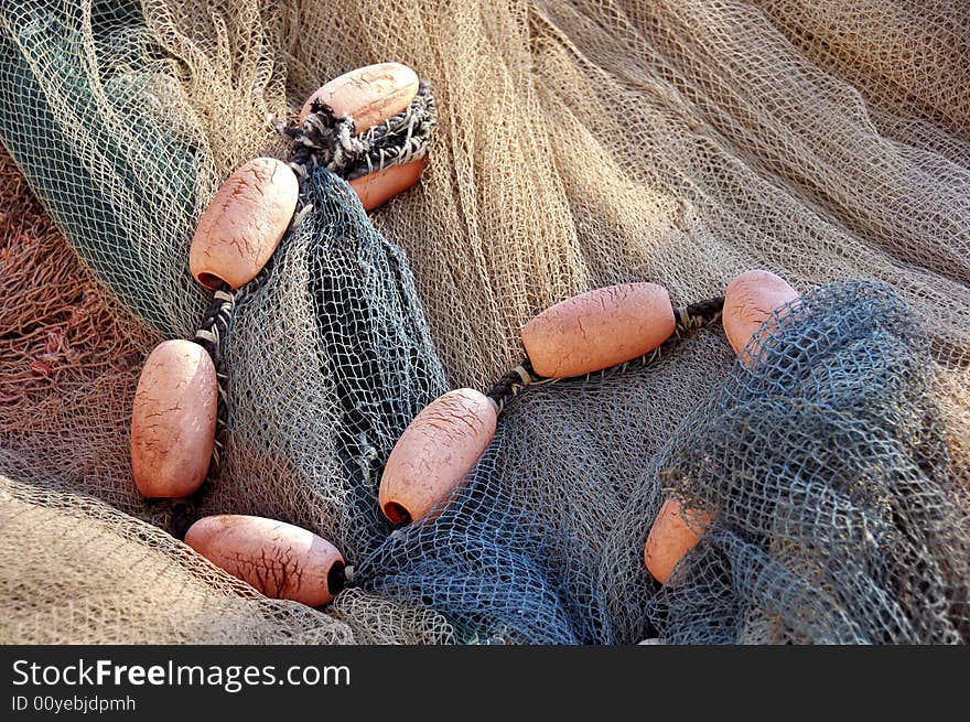 Close up of colored fishing net with floats.