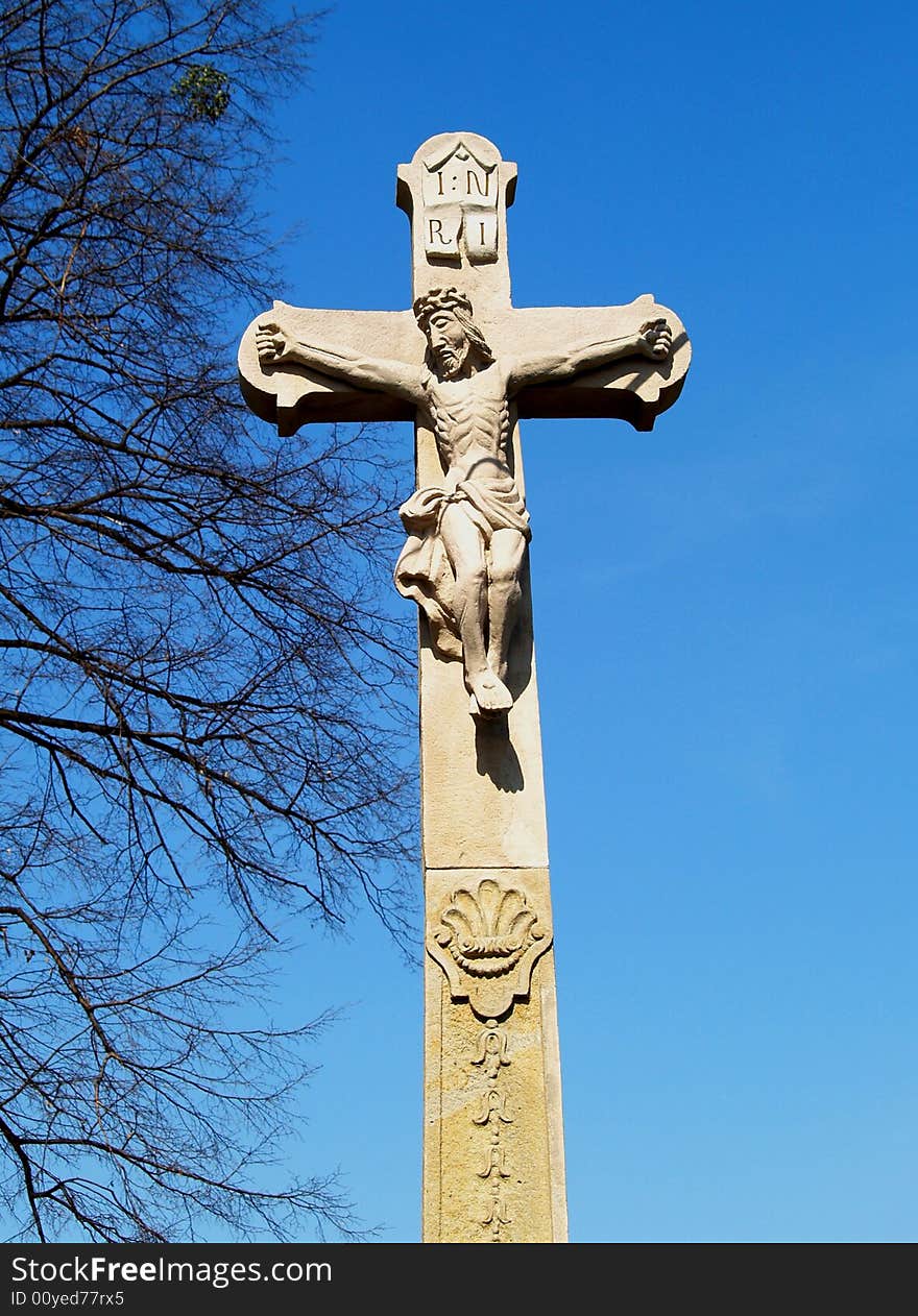 Stone crucifix with Jesus sculpture. Stone crucifix with Jesus sculpture