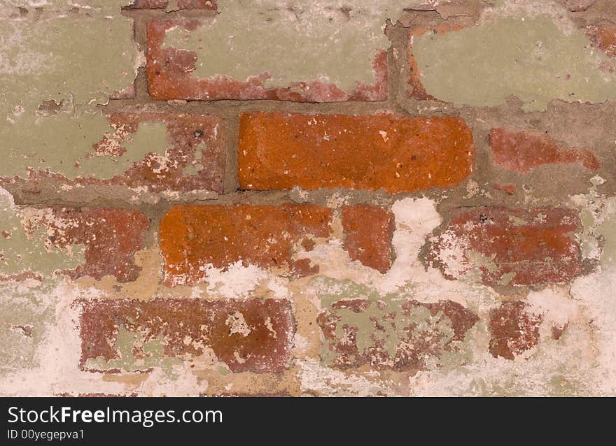 A close-up of a flaking brick wall. A close-up of a flaking brick wall