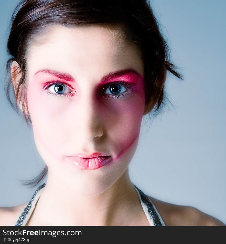 Close studio portrait of a pretty brunette with special artistic cosmetics. Close studio portrait of a pretty brunette with special artistic cosmetics