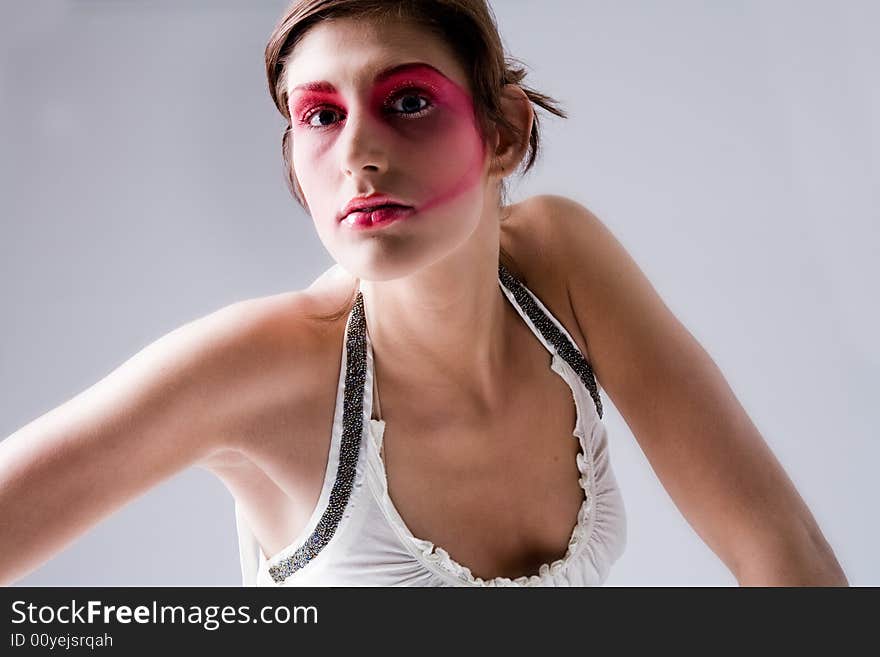 Close studio portrait of a pretty brunette with special artistic cosmetics. Close studio portrait of a pretty brunette with special artistic cosmetics