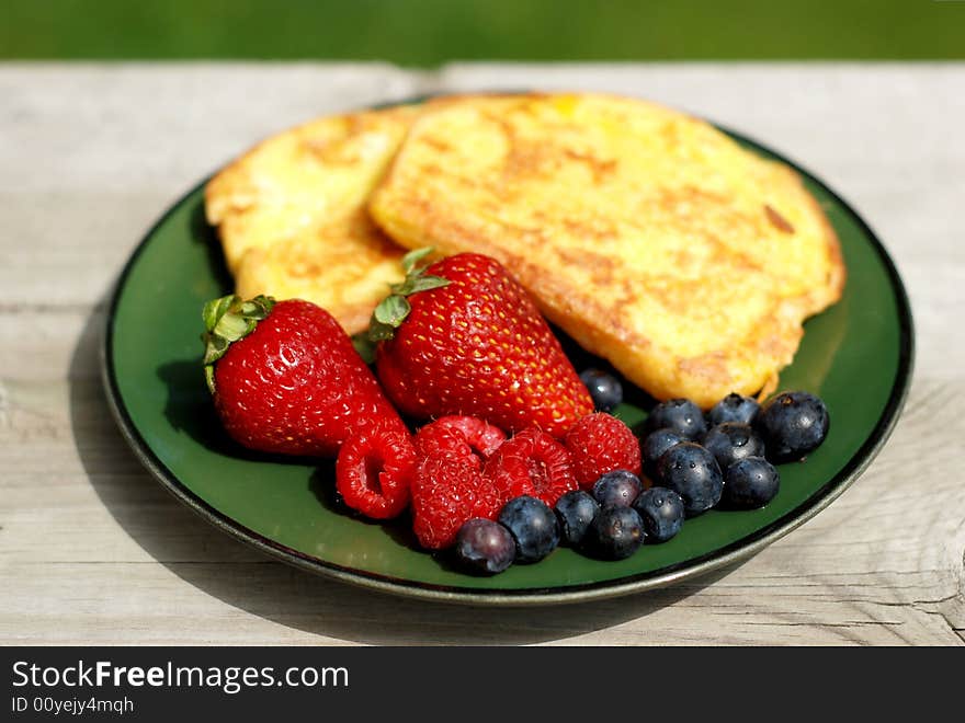 French toast breakfast with fresh berries outdoors