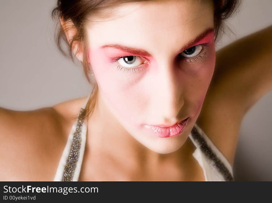 Close studio portrait of a pretty brunette with special artistic cosmetics. Close studio portrait of a pretty brunette with special artistic cosmetics