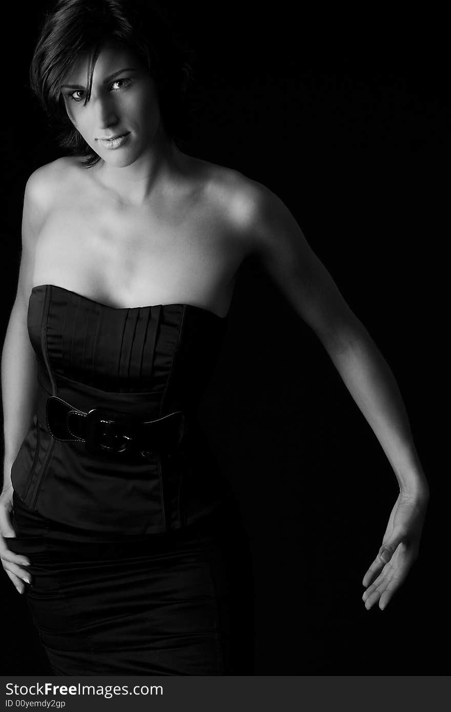 Studio portrait of a tall lady in a black dress on a black background. Studio portrait of a tall lady in a black dress on a black background