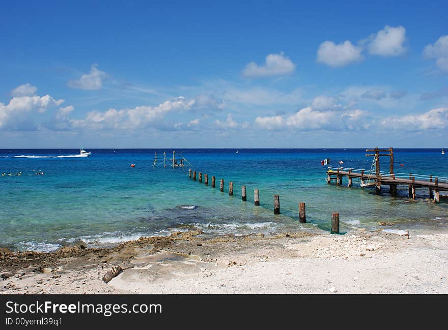 People building the wooden pier on Cozumel island beach, Mexico. People building the wooden pier on Cozumel island beach, Mexico.