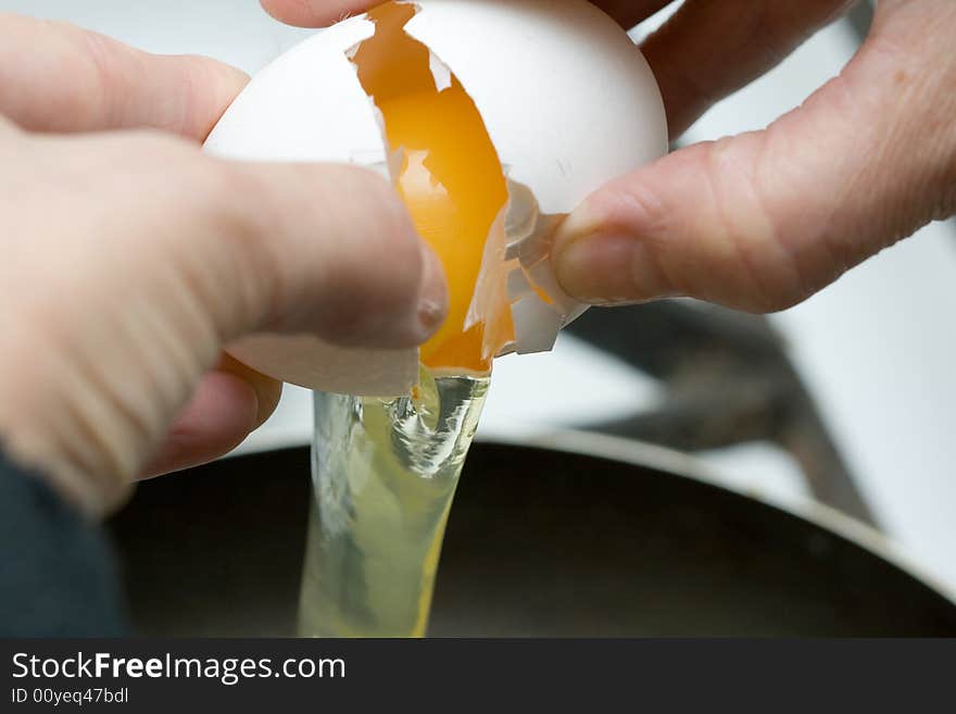 Frying the egg in griddle close-up