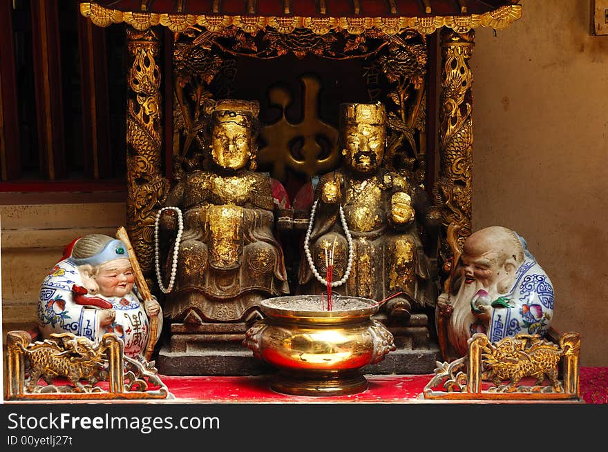 In Thailand the city of Ayutthaya was founded in 1350 today is an impressive archaeological park; here a view of an altar inside a Chinese temple on the back of Wat Phanan-Choeng. In Thailand the city of Ayutthaya was founded in 1350 today is an impressive archaeological park; here a view of an altar inside a Chinese temple on the back of Wat Phanan-Choeng