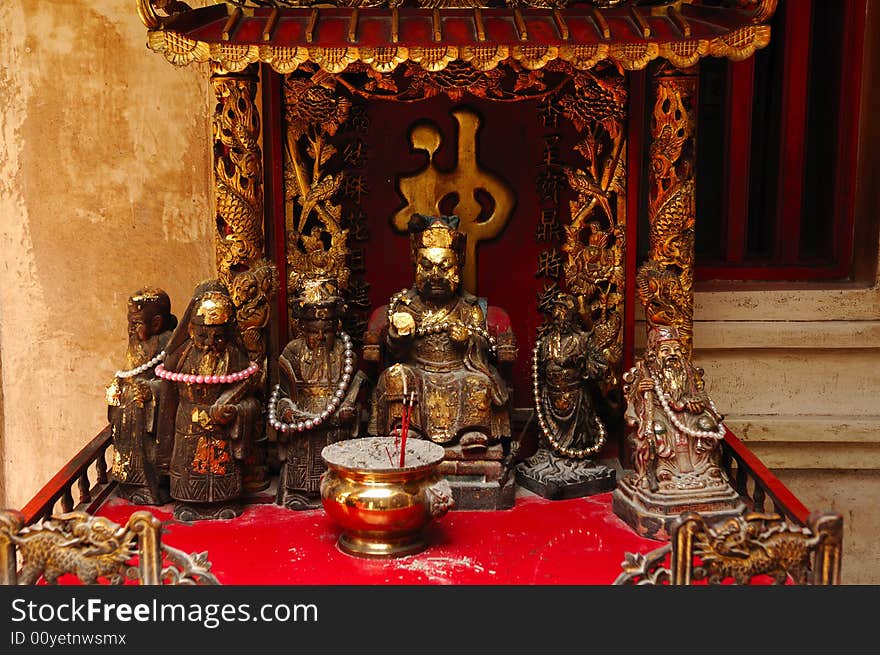 In Thailand the city of Ayutthaya was founded in 1350 today is an impressive archaeological park; here a view of a altar inside a Chinese temple on the back of Wat Phanan-Choeng. In Thailand the city of Ayutthaya was founded in 1350 today is an impressive archaeological park; here a view of a altar inside a Chinese temple on the back of Wat Phanan-Choeng