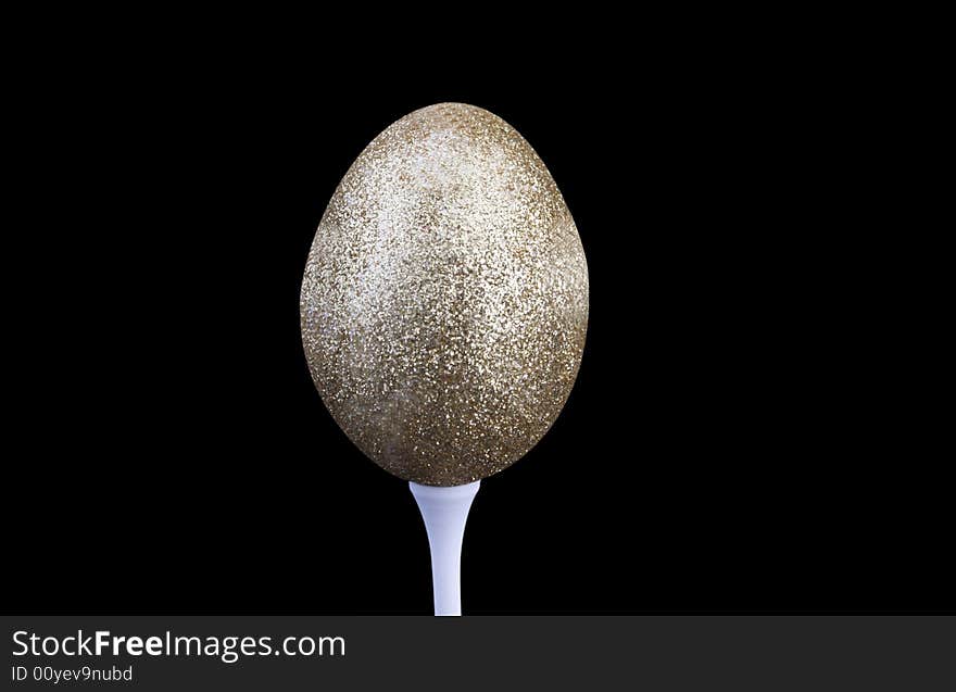 Golden nest egg on tee with clipping path