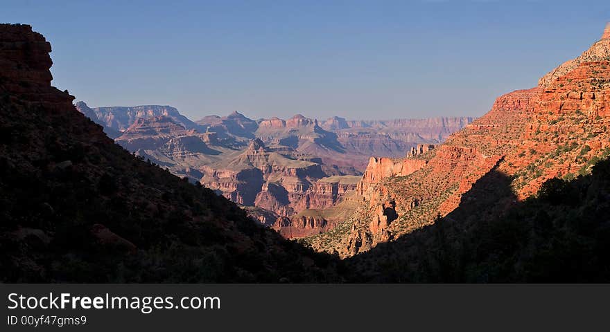 Sunset lit Grand Canyon viewt from narrow canyon.