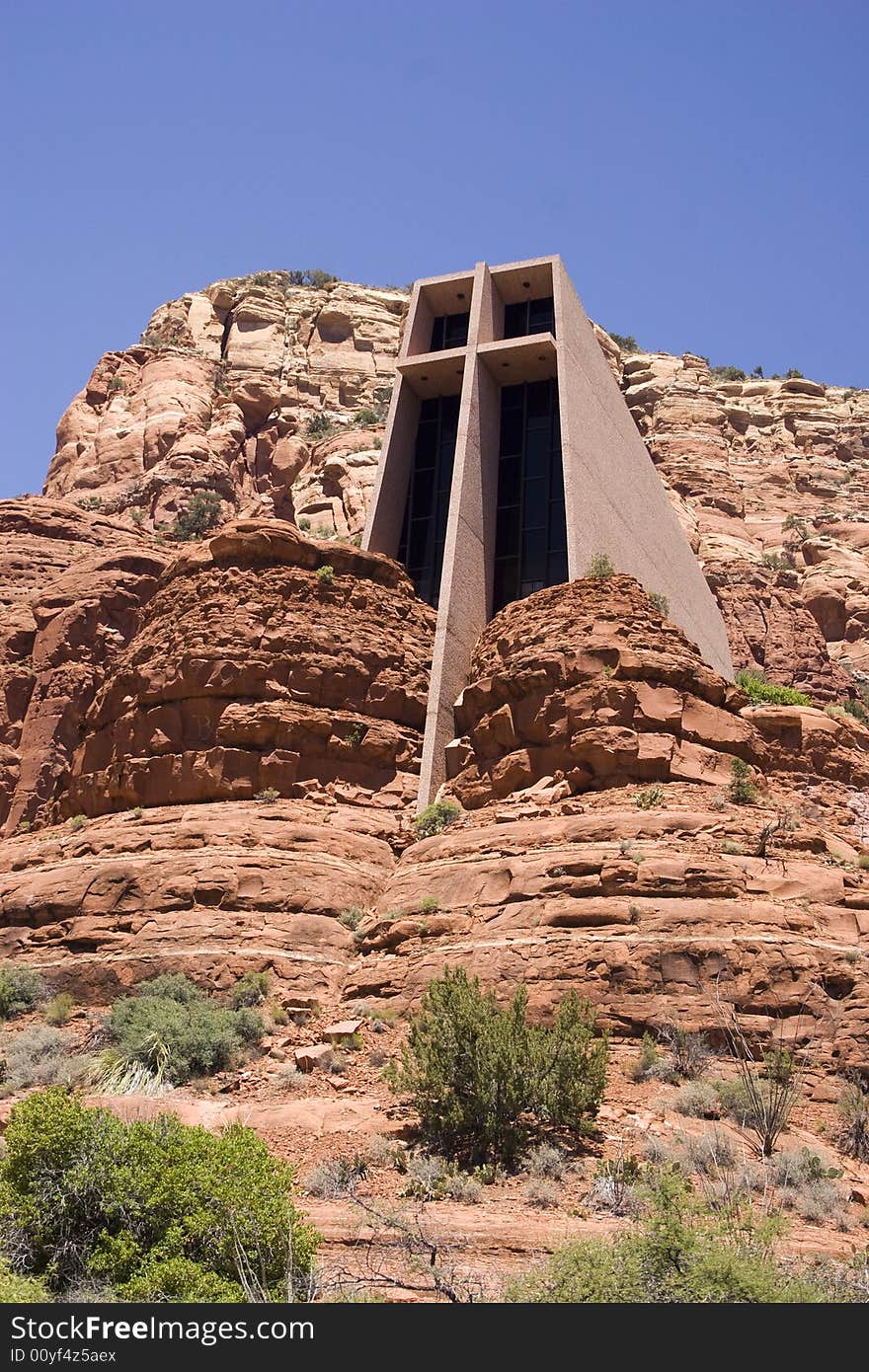 Chapel of the Holy Cross in Sedona, Arizona. The chapel was Designed by a Frank Lloyd Wright student, Marguerite Brunswig Staude. The chapel was built in 1956 and rises 200 feet from the ground between two large red rock formations. A massive stained glass window turns the chapel's interior into a kaleidoscope of color at certain times of the day. Chapel of the Holy Cross in Sedona, Arizona. The chapel was Designed by a Frank Lloyd Wright student, Marguerite Brunswig Staude. The chapel was built in 1956 and rises 200 feet from the ground between two large red rock formations. A massive stained glass window turns the chapel's interior into a kaleidoscope of color at certain times of the day.