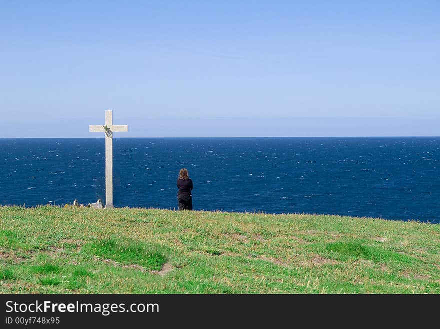 Widow in black watching the sea beside death triburte