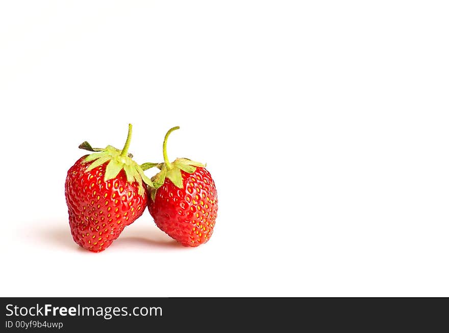 Two strawberries on white background, lots of copy space