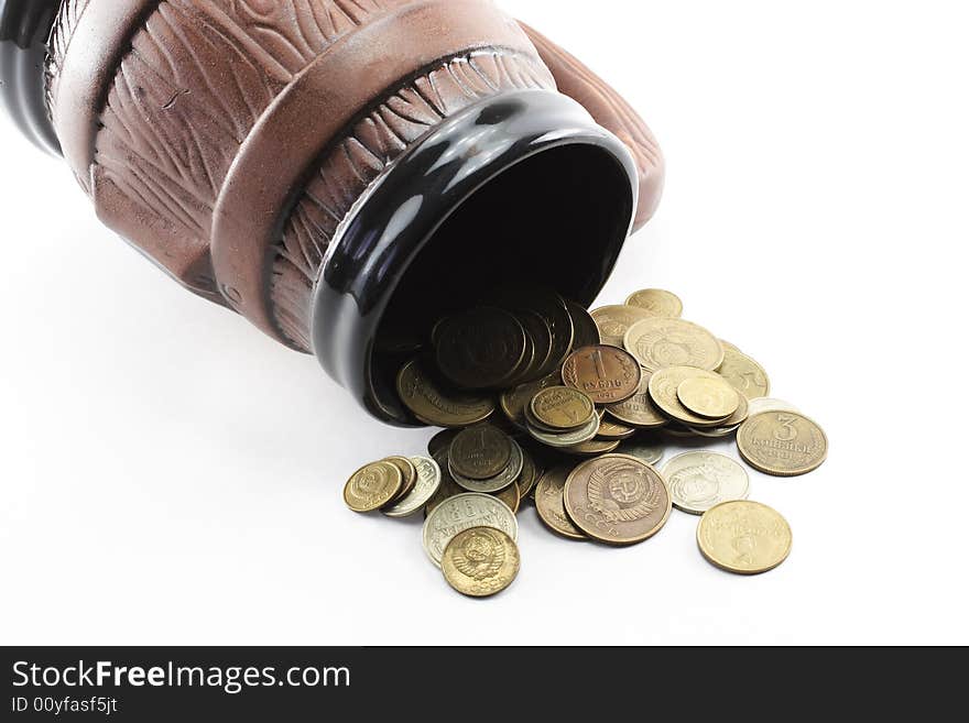 Brown clay mug and coins. Brown clay mug and coins