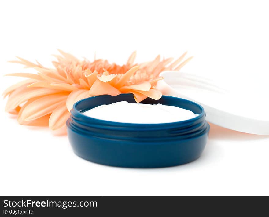 Moisturizing cream with orange gerbera close up