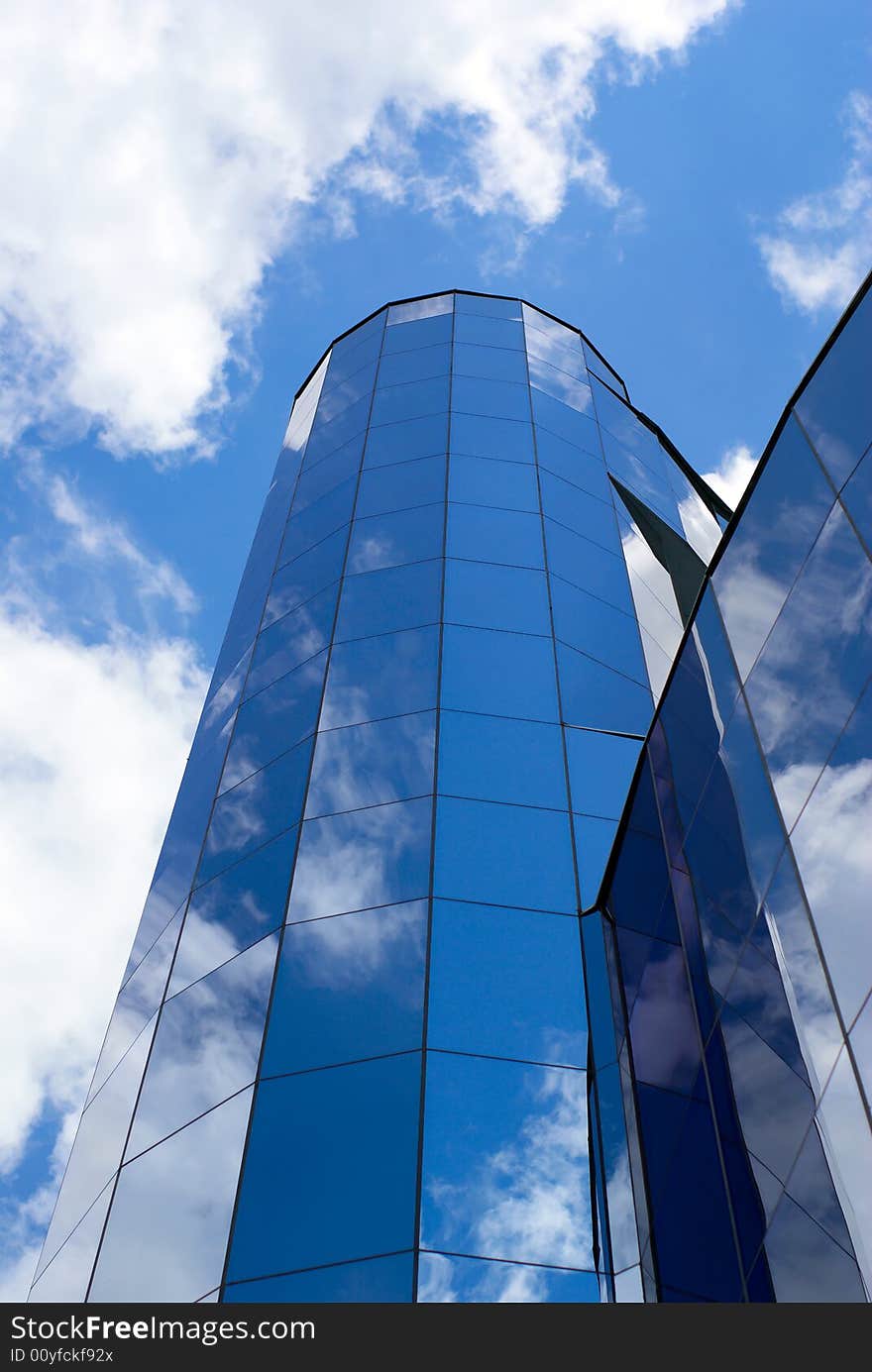 Clouds and sky reflect in glass tower. Clouds and sky reflect in glass tower