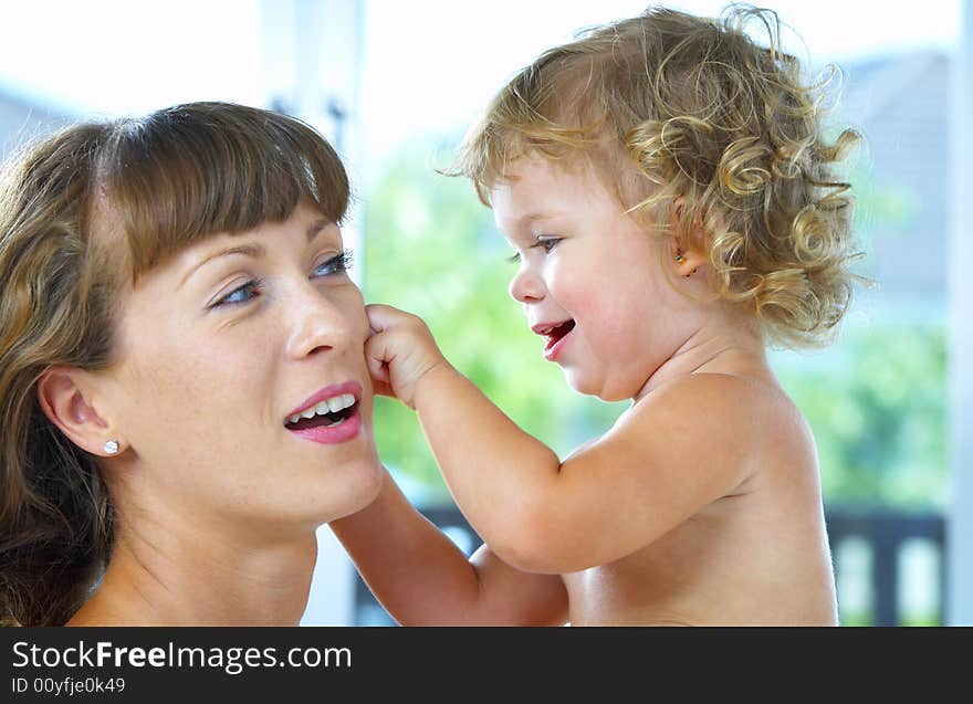 High key portrait of happy mother with baby. High key portrait of happy mother with baby