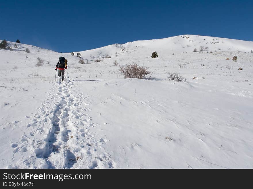 Hikers are in winter in mountains. Hikers are in winter in mountains