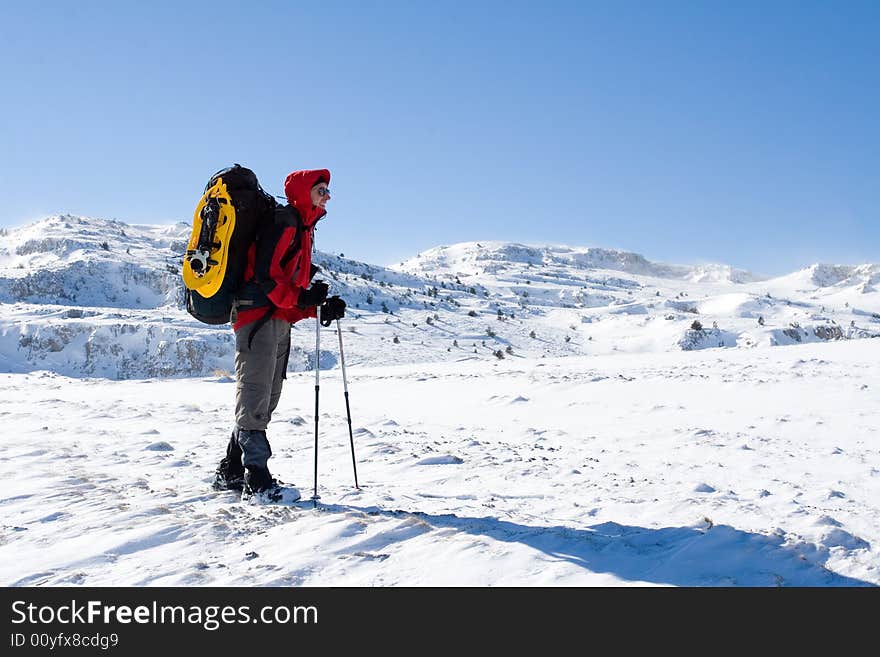 Hiker are in winter in mountains. Hiker are in winter in mountains