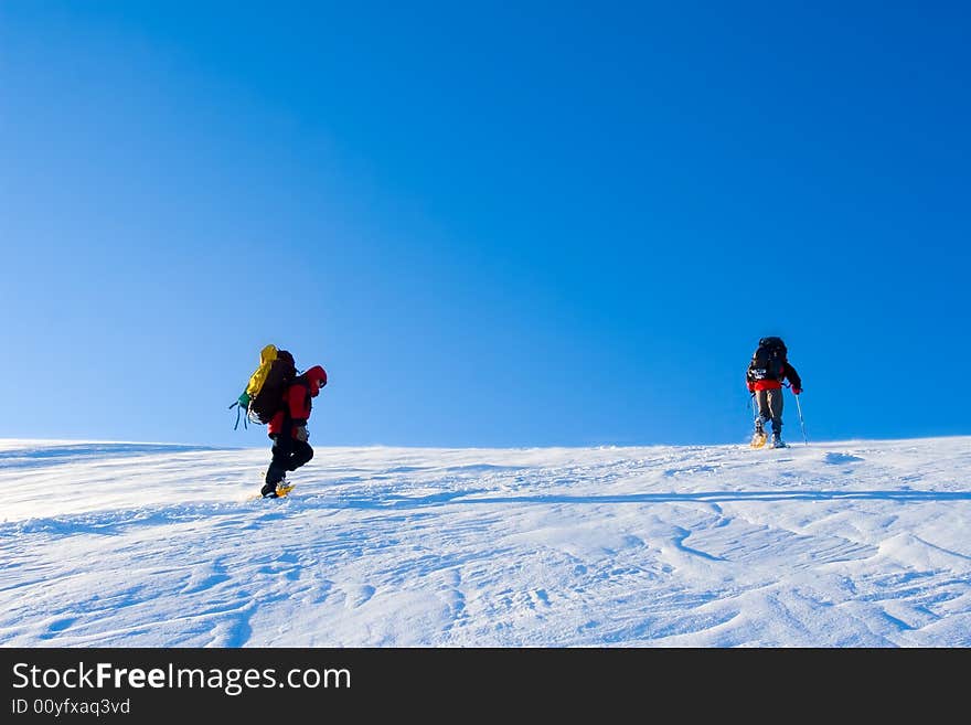 Hikers are in winter in mountains. Hikers are in winter in mountains