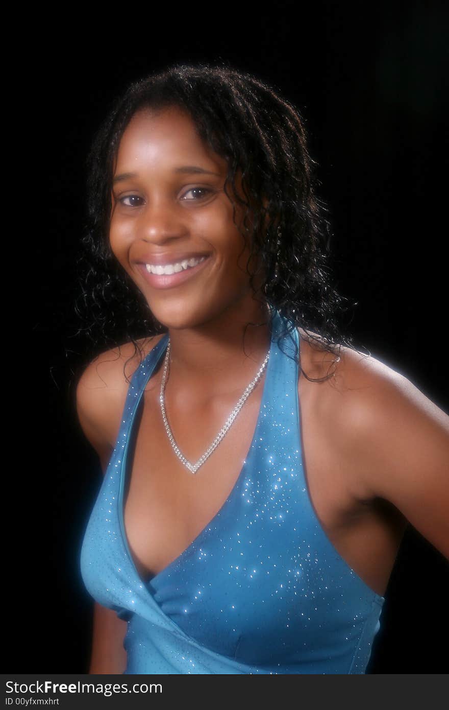 Pretty teenage girl in sparkly blue halter gown; head and shoulders shot. Pretty teenage girl in sparkly blue halter gown; head and shoulders shot.