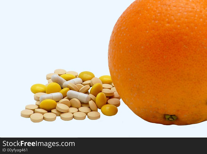 Vitamins and orange isolated on the white background. Vitamins and orange isolated on the white background