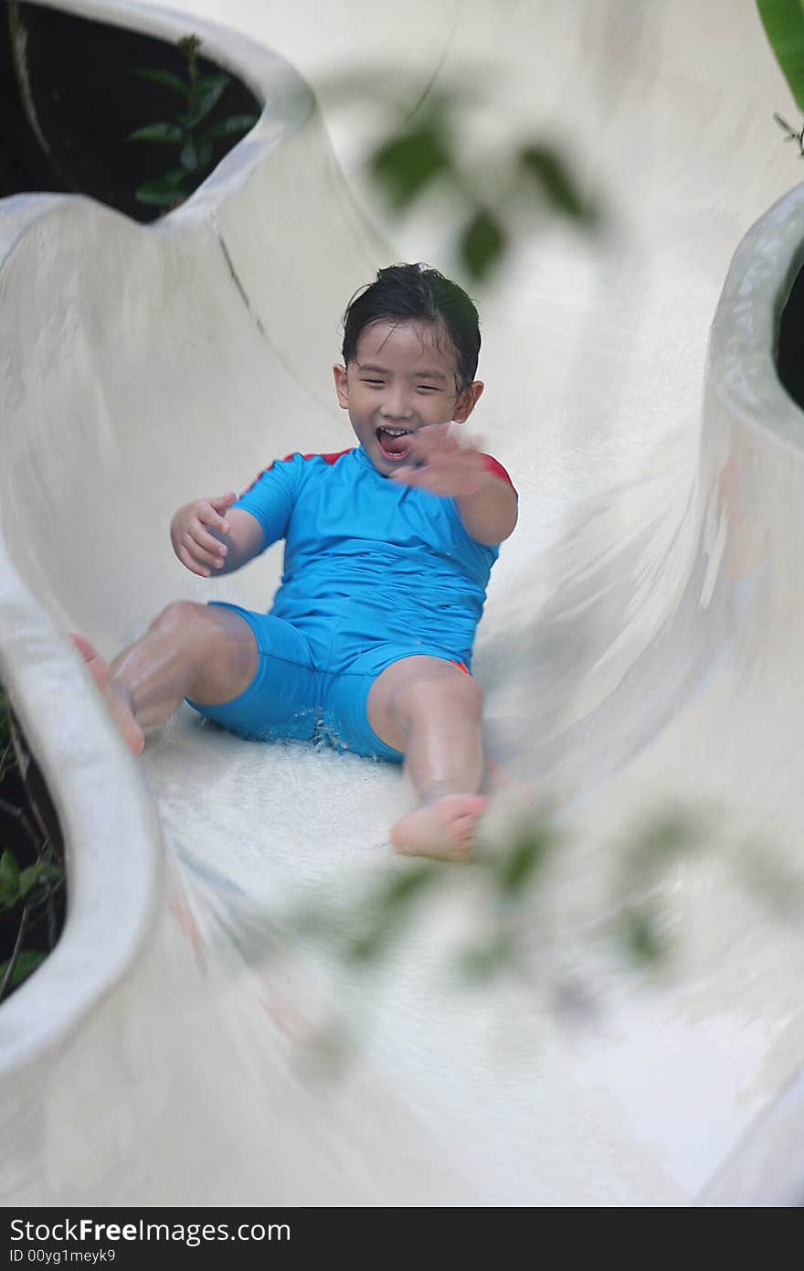 Boy Sliding At The Pool