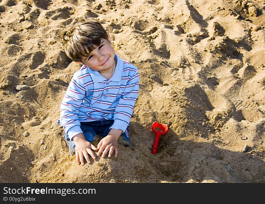 The Boy Playing In The Sand