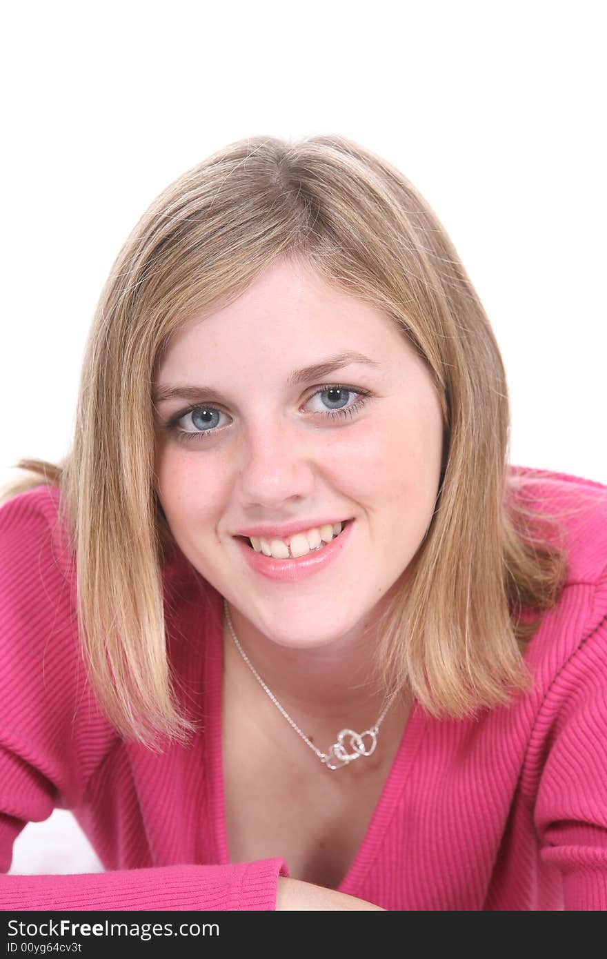 Pretty teenage girl in pink shirt against a white background.