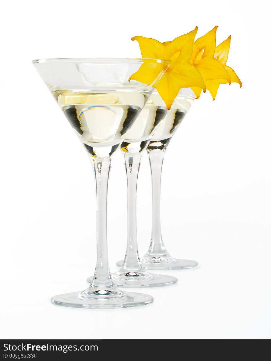 Glass of martini and slice of carambola on a white background. Glass of martini and slice of carambola on a white background