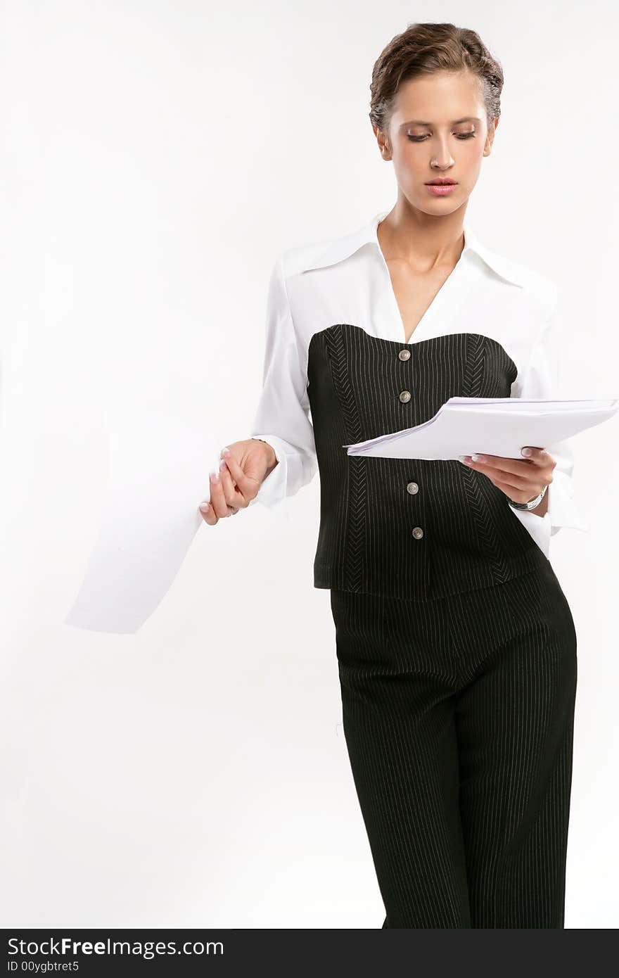 Attractive Fine business-lady Looks at a pack of papers. Attractive Fine business-lady Looks at a pack of papers