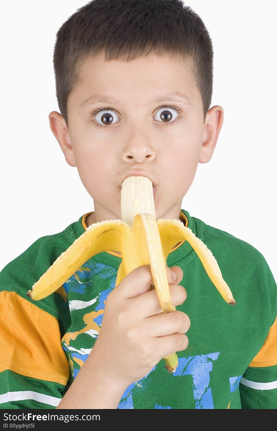 Boy eating banana isolated on white background
