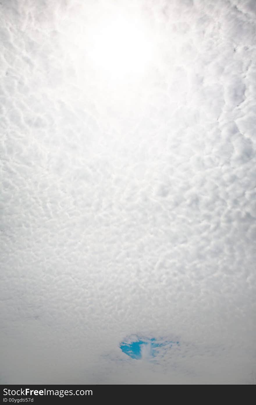 Cloudscape: small clouds and a piece of sky, vertical orientation. Cloudscape: small clouds and a piece of sky, vertical orientation