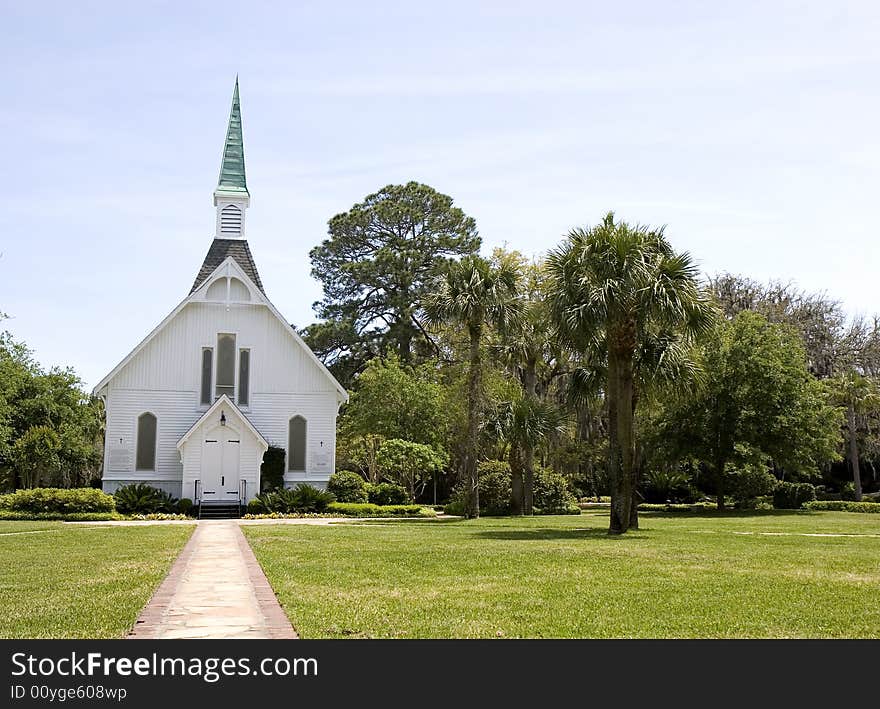 A small church along a path through the grass. A small church along a path through the grass