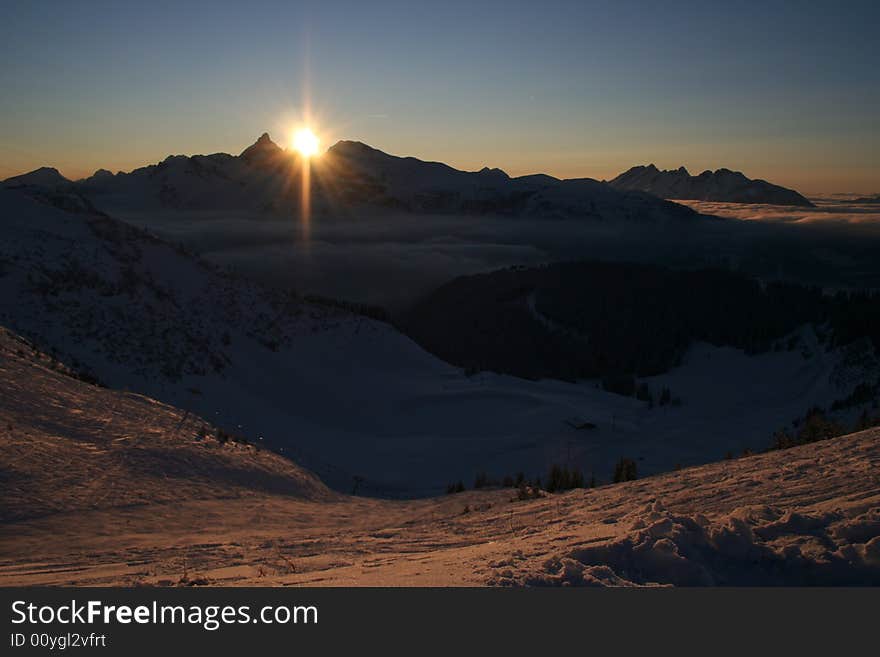 Winter mountains with sunset skies. Winter mountains with sunset skies