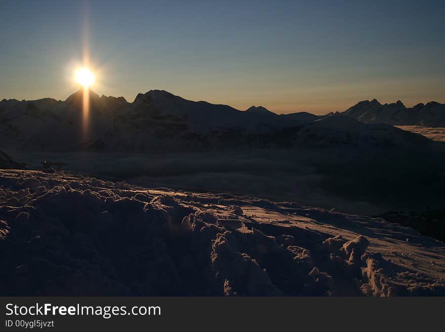 Winter mountains with sunset skies. Winter mountains with sunset skies