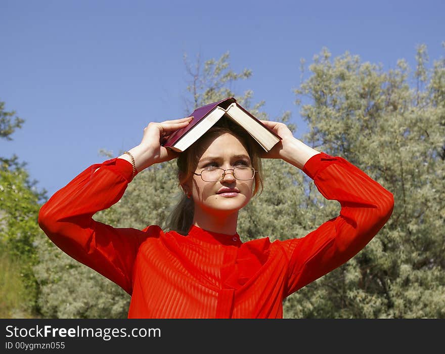 Smiling woman in red holding a book