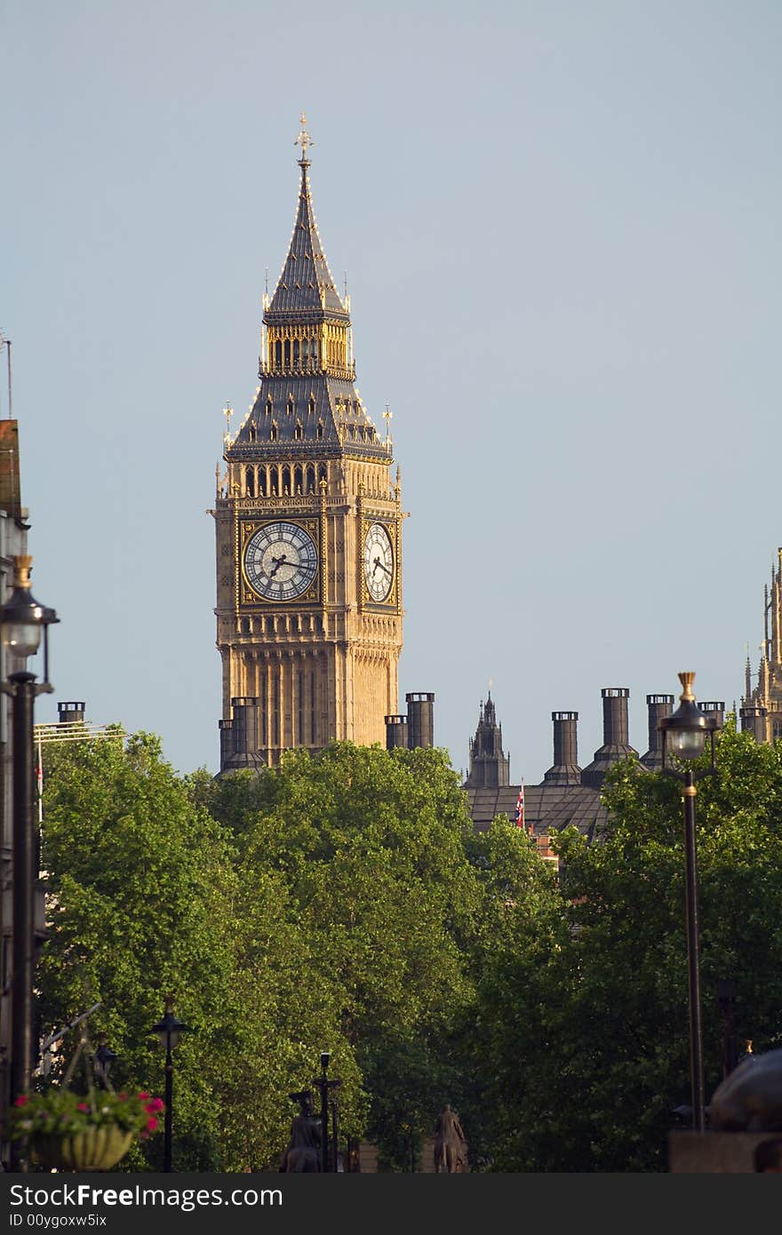 Big Ben and Westminster Clock Tower over a stand of trees. Big Ben and Westminster Clock Tower over a stand of trees