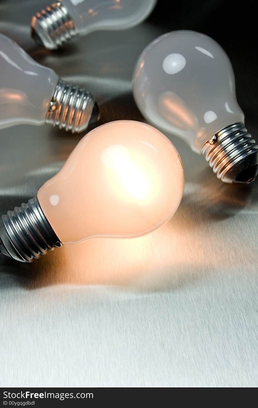 Series of lightbulbs on metal desk